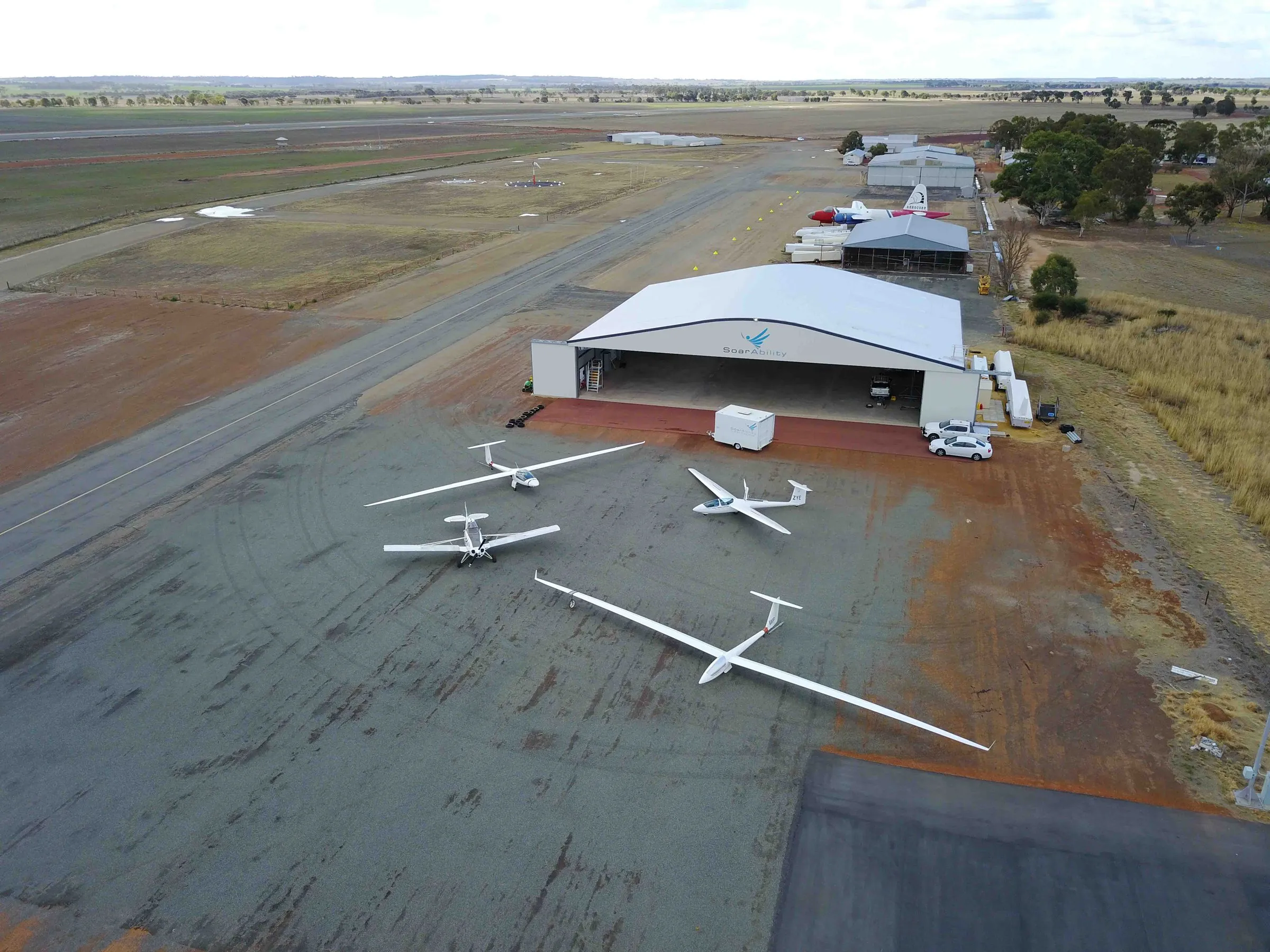 Aerial view of the SoarAbility hangar at Cunderdin Airfield, gliders lined up on the apron below